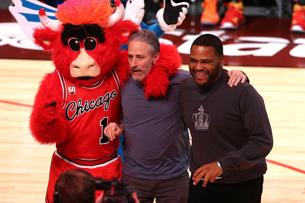 Jon Stewart at the 2016 NBA All-Star Game with Benny the Bull and Anthony Anderson.