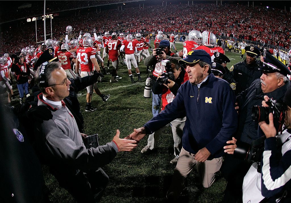 COLUMBUS, OH - NOVEMBER 18: Head coach Jim Tressel of the Ohio State Buckeyes is congratulated by head coach Lloyd Carr of the Michigan Wolverines November 18, 2006 at Ohio Stadium in Columbus, Ohio. Ohio State won 42-39. (Photo by Gregory Shamus/Getty Images)