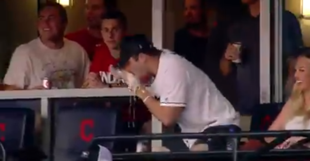 Baker Mayfield shotgunning a beer at an Indians' game.