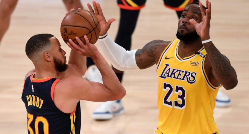 The Lakers' LeBron James tries to defend the Warriors' Steph Curry.
