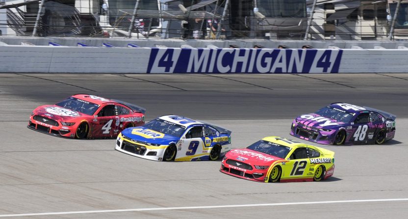 Aug 22, 2021; Brooklyn, Michigan, USA; NASCAR Cup Series driver Kevin Harvick (4), driver Chase Elliott (9) and driver Ryan Blaney (12) race three wide during the FireKeepers Casino 400 at Michigan International Speedway.