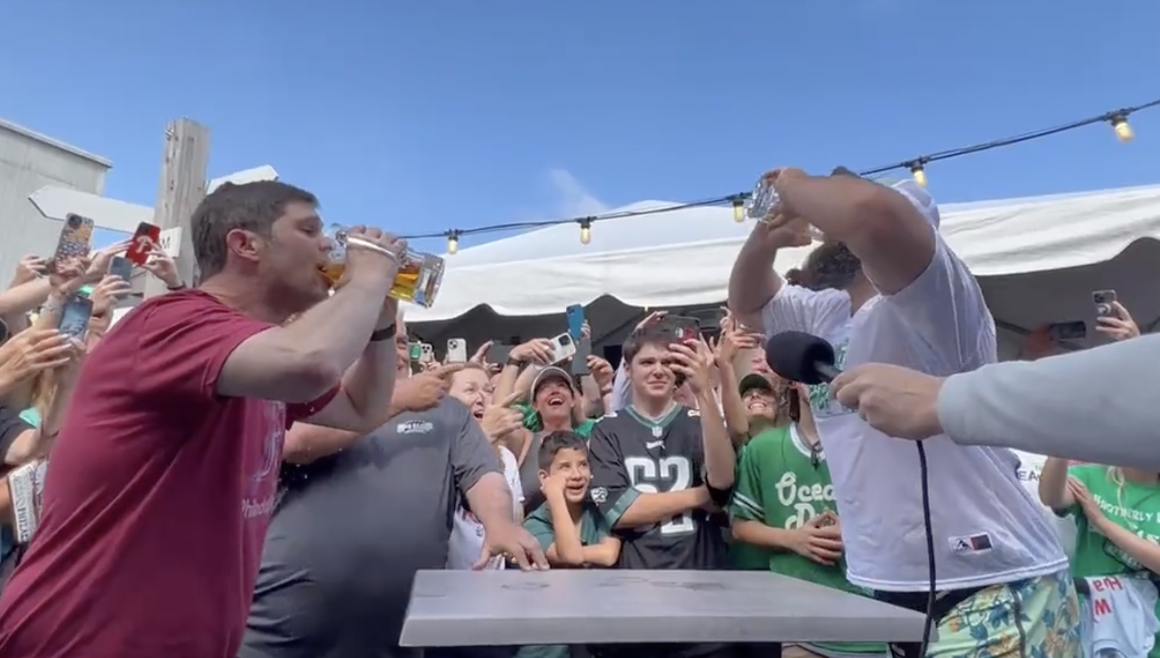 Jason Kelce and James Seltzer chugging beer for charity.