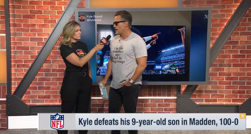 Kyle Brandt giving a fake interview to Jamie Erdahl about his 100-0 Madden win against his son.