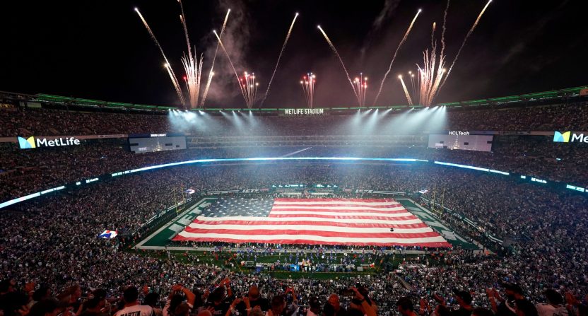 The New York Jets display a giant American flag during the singing of the national anthem for the home opener against the Buffalo Bills at MetLife Stadium on Monday, Sept. 11, 2023, in East Rutherford.