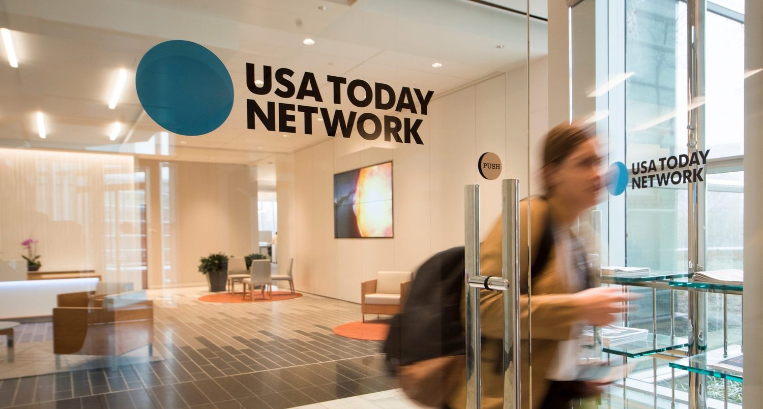 USA Today Sports layoffs leaving a modern newsroom empty during corporate restructuring