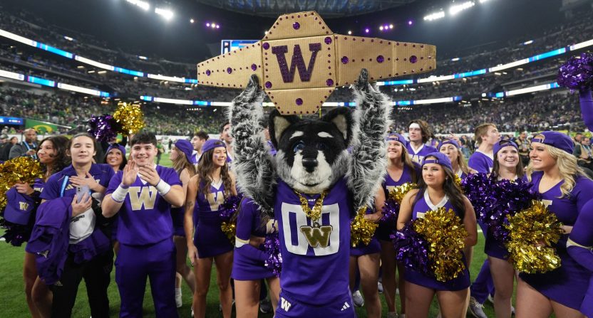 Washington Huskies mascot Harry the Husky and cheerleaders pose after the Pac-12 Championship game against the Oregon Ducks at Allegiant Stadium.
