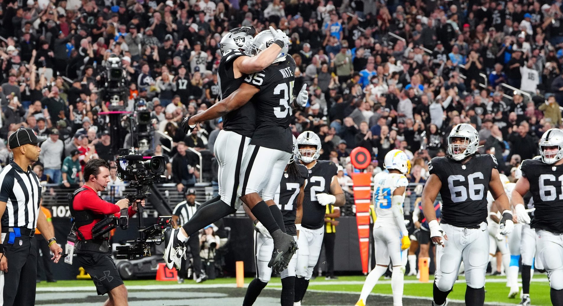 Las Vegas Raiders tight end Michael Mayer (87) celebrates after scoring a touchdown with running back Zamir White (35) in the second quarter against the Los Angeles Chargers at Allegiant Stadium.