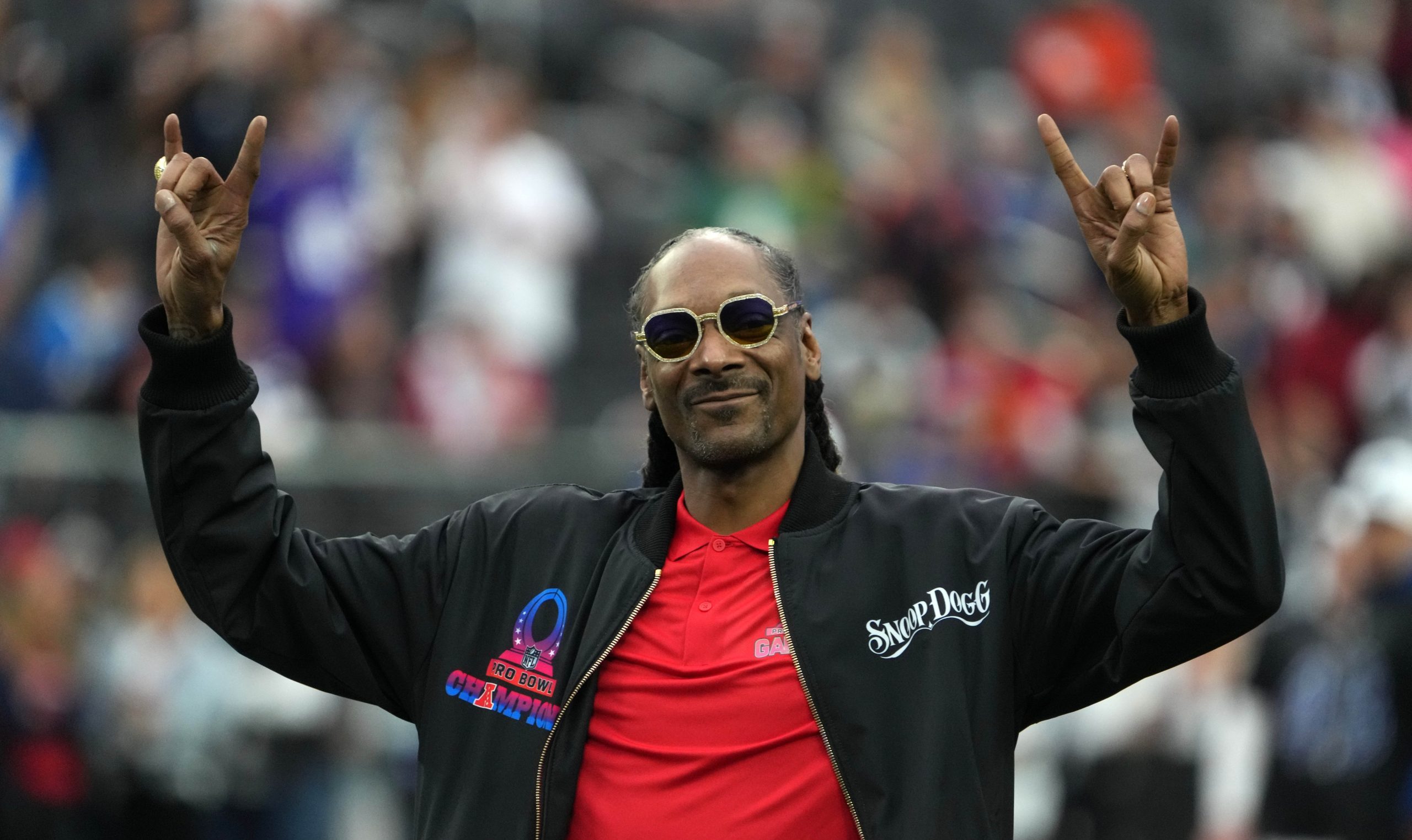 AFC captain and recording artist Snoop Dogg watches from the sidelines against the NFC during the Pro Bowl Games at Allegiant Stadium.