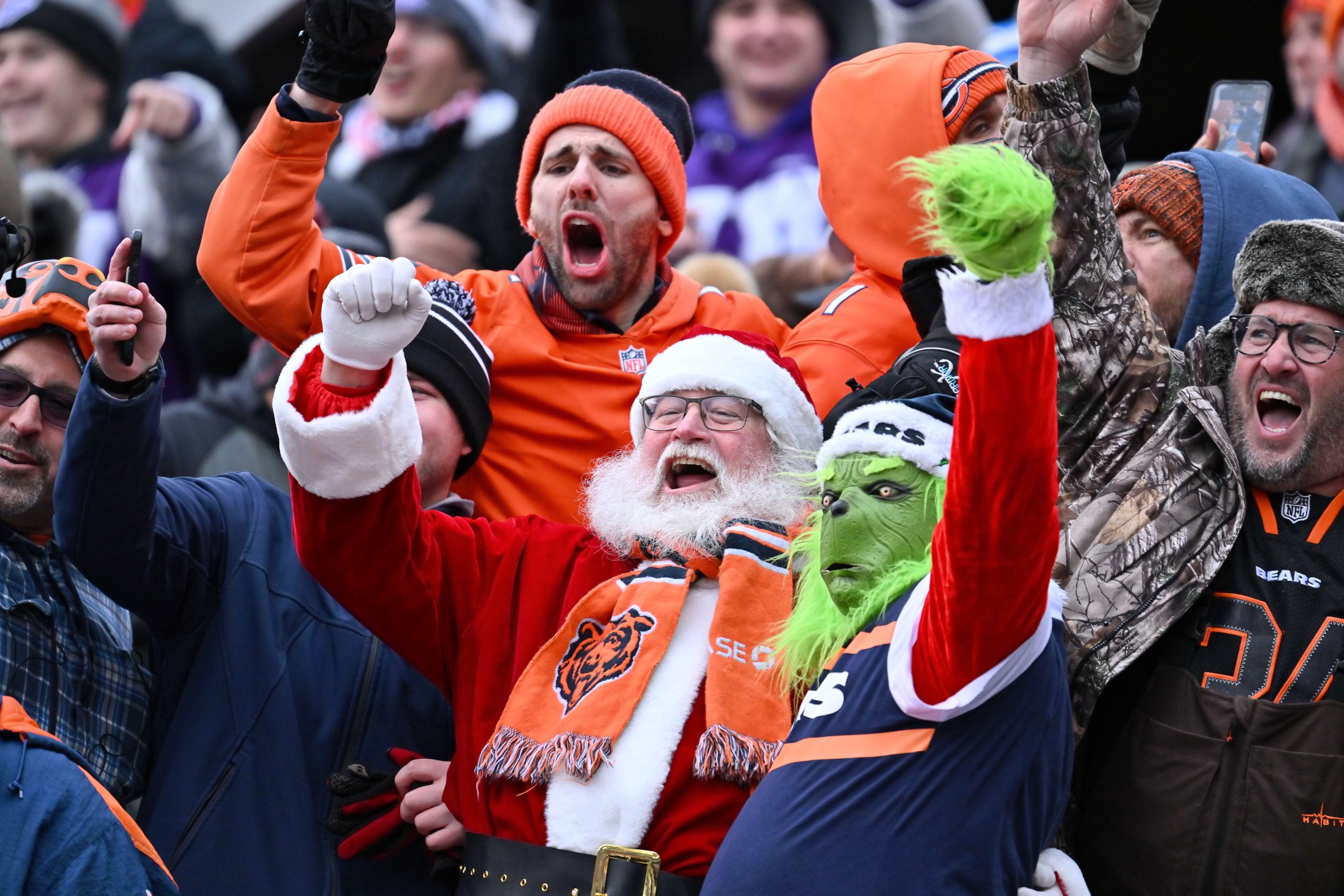 Dec 10, 2023; Chicago, Illinois, USA; Santa Claus, the Grinch and other fans cheer for the Chicago Bears in the second half during a game against the Detroit Lions at Soldier Field.