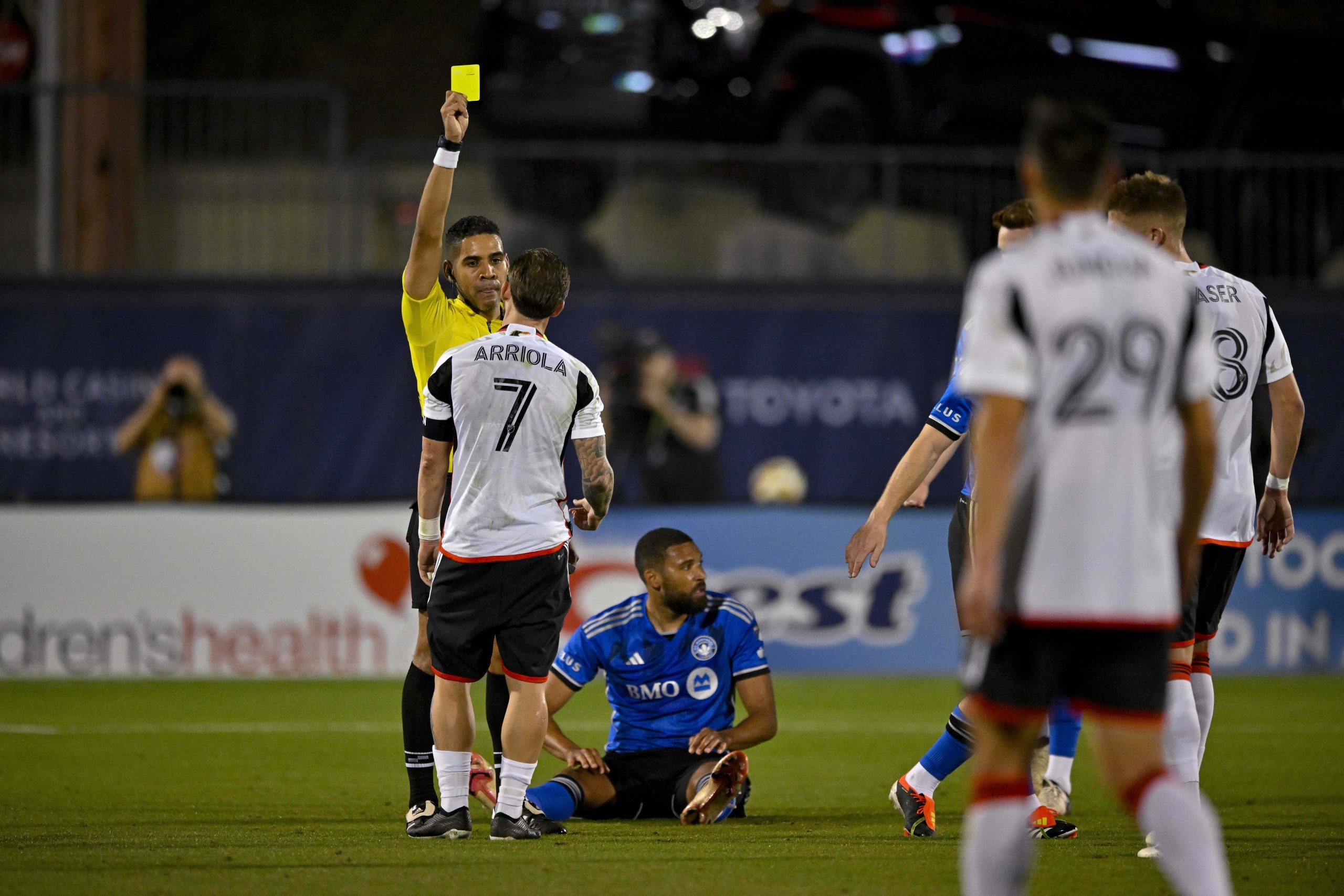 Mar 2, 2024; Frisco, Texas, USA; FC Dallas forward Paul Arriola (7) is issued a yellow card by MLS referee Kyle Johnston during the second half against CF Montreal at Toyota Stadium.