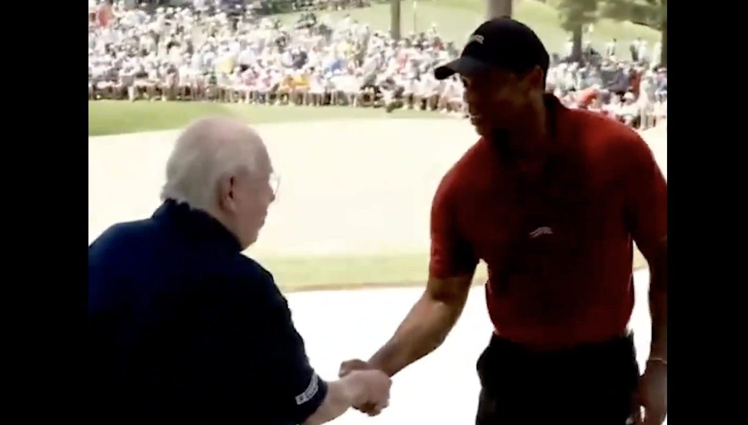 Verne Lundquist and Tiger Woods shake hands at the Masters