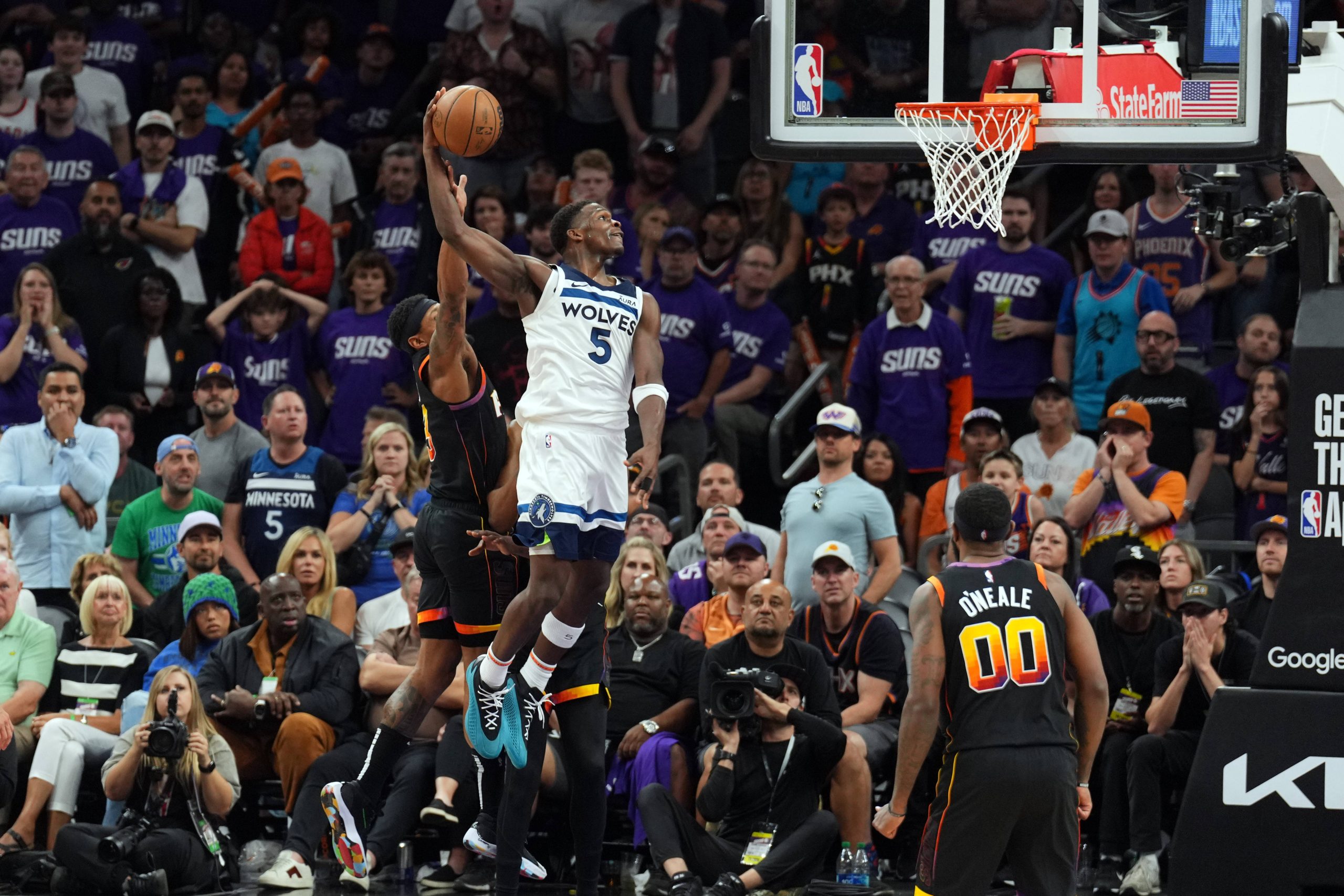 Apr 28, 2024; Phoenix, Arizona, USA; Minnesota Timberwolves guard Anthony Edwards (5) dunks against the Phoenix Suns during the second half of game four of the first round for the 2024 NBA playoffs at Footprint Center.