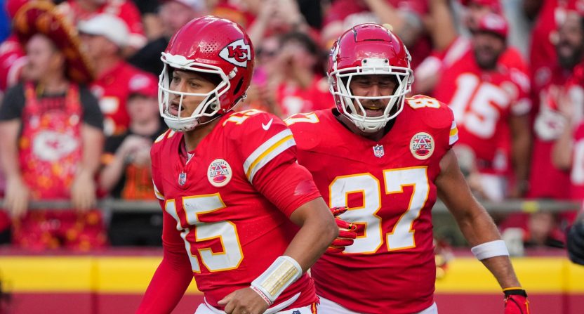 Sep 15, 2024; Kansas City, Missouri, USA; Kansas City Chiefs quarterback Patrick Mahomes (15) and tight end Travis Kelce (87) return to the sidelines after a score against the Cincinnati Bengals during the first half at GEHA Field at Arrowhead Stadium.