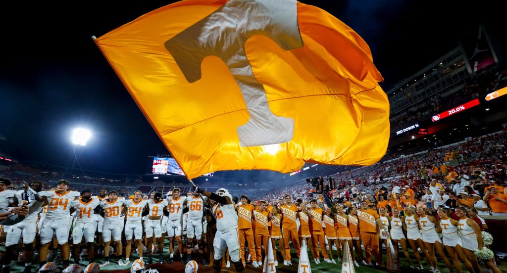 Tennessee Volunteers' offensive lineman Javontez Spraggins (76) waves a flag after beating the Oklahoma Sooners on the road on Sept. 21, 2024.