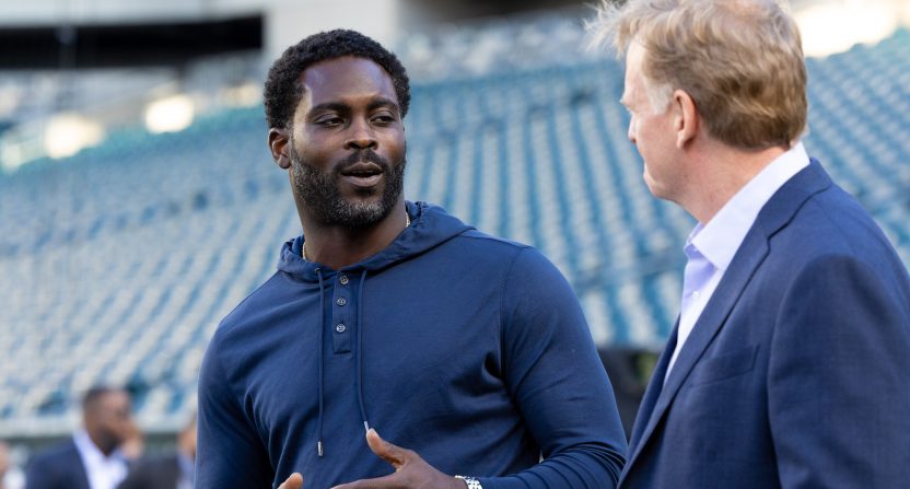 NFL commissioner Roger Goodell (R) talks with former player Michael Vick (L) before a game between the Philadelphia Eagles and the Minnesota Vikings at Lincoln Financial Field.