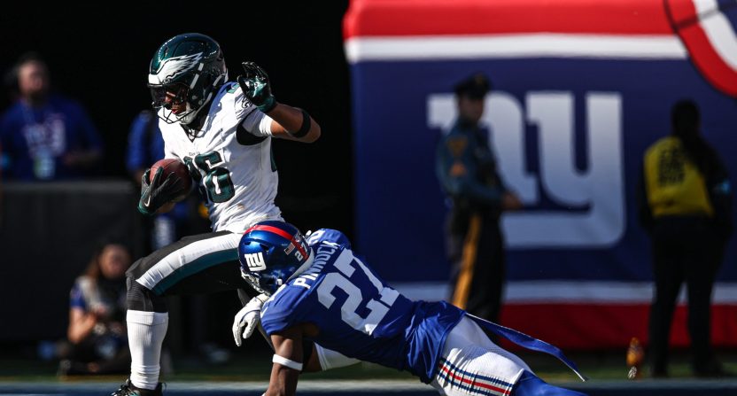 Oct 20, 2024; East Rutherford, New Jersey, USA; Philadelphia Eagles running back Saquon Barkley (26) carries the ball as New York Giants safety Jason Pinnock (27) pursues during the second half at MetLife Stadium.