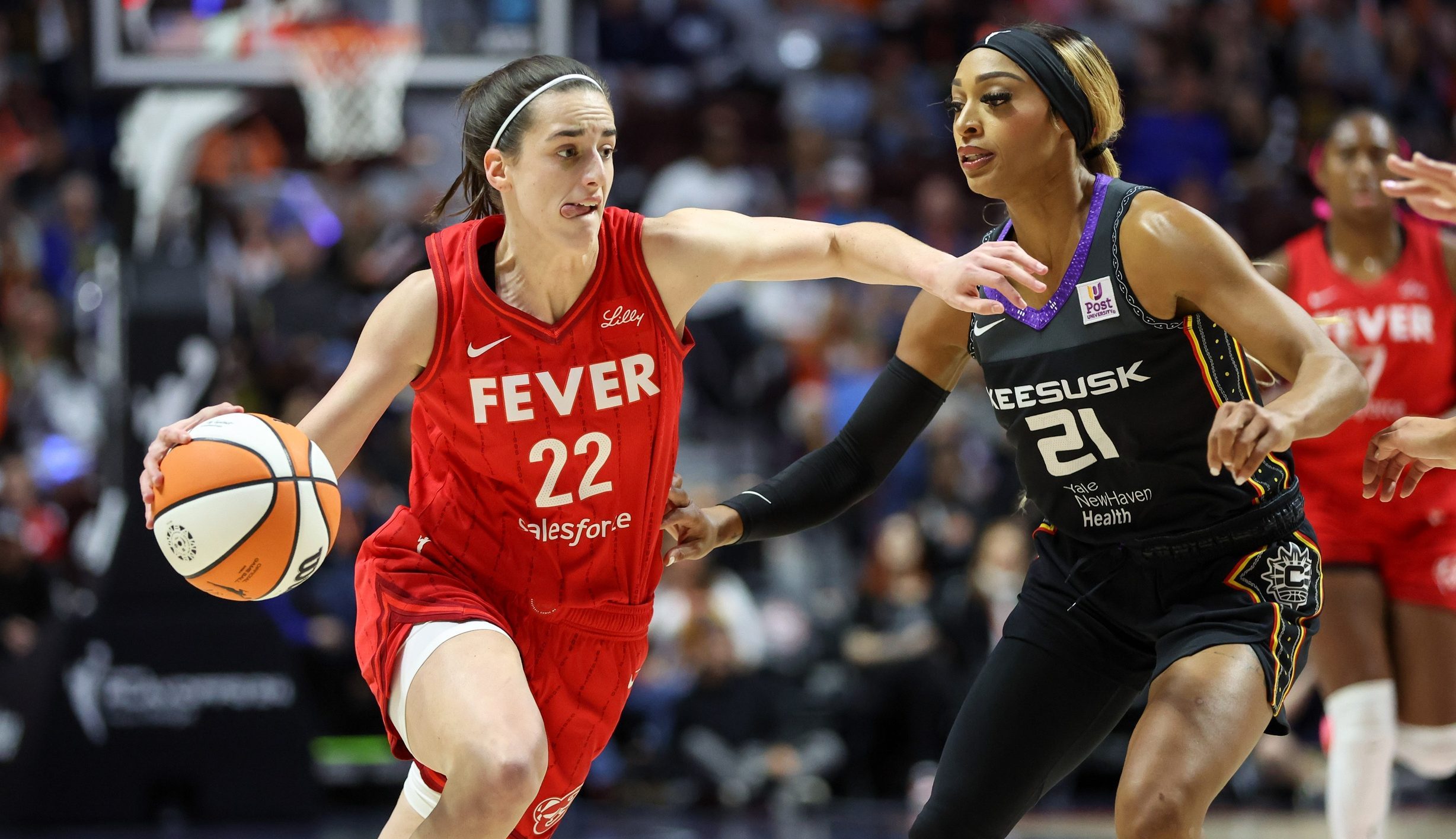 Sep 25, 2024; Uncasville, Connecticut, USA; Indiana Fever guard Caitlin Clark (22) drives to the basket defended by Connecticut Sun guard DiJonai Carrington (21) during the first half during game two of the first round of the 2024 WNBA Playoffs at Mohegan Sun Arena.