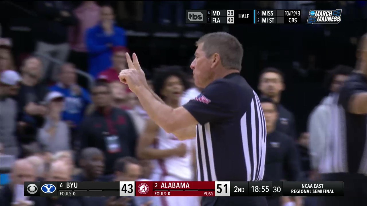 Referee Tony Padilla assesses a technical foul to BYU's Trevin Knell. Photo Credit: CBS