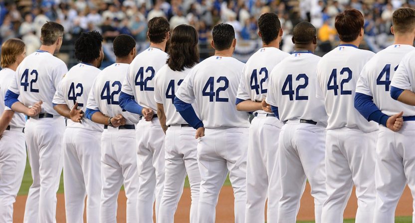 Los Angeles Dodgers line up for the National Anthem to commemorate Jackie Robinson Day before the game against the Seattle Mariners at Dodger Stadium.