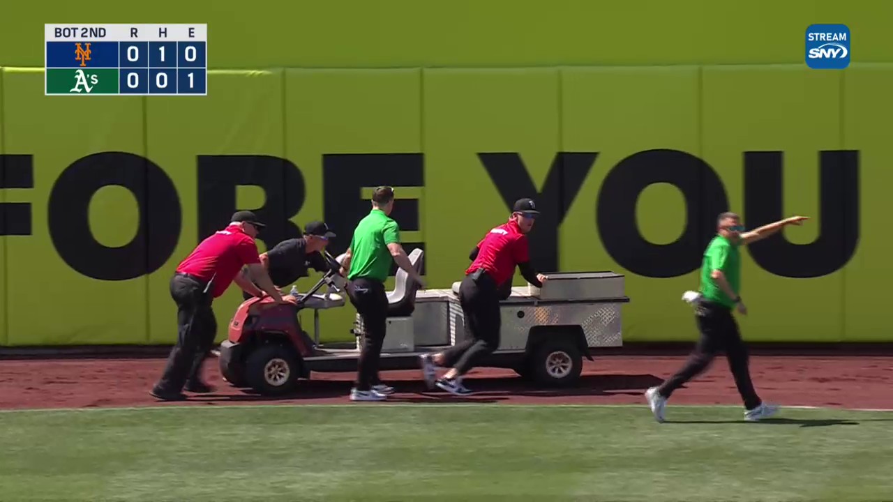Members of the Athletics groundscrew push a cart off the field after it broke down. Photo credit: SNY