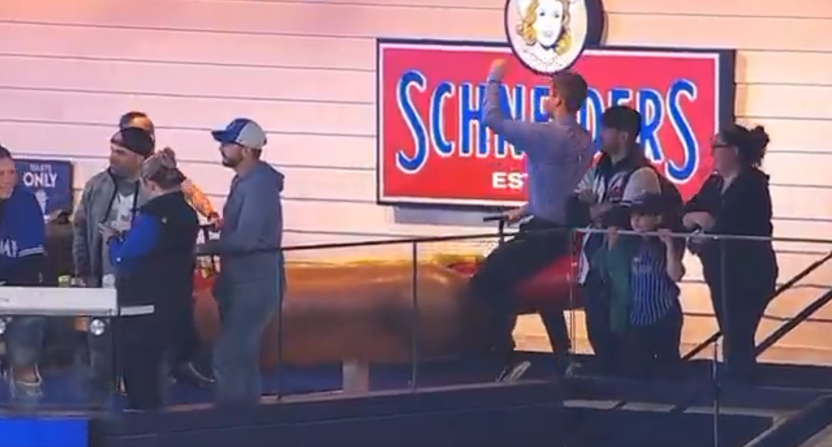 Atlanta Braves reporter Wiley Ballard rides a hotdog seesaw