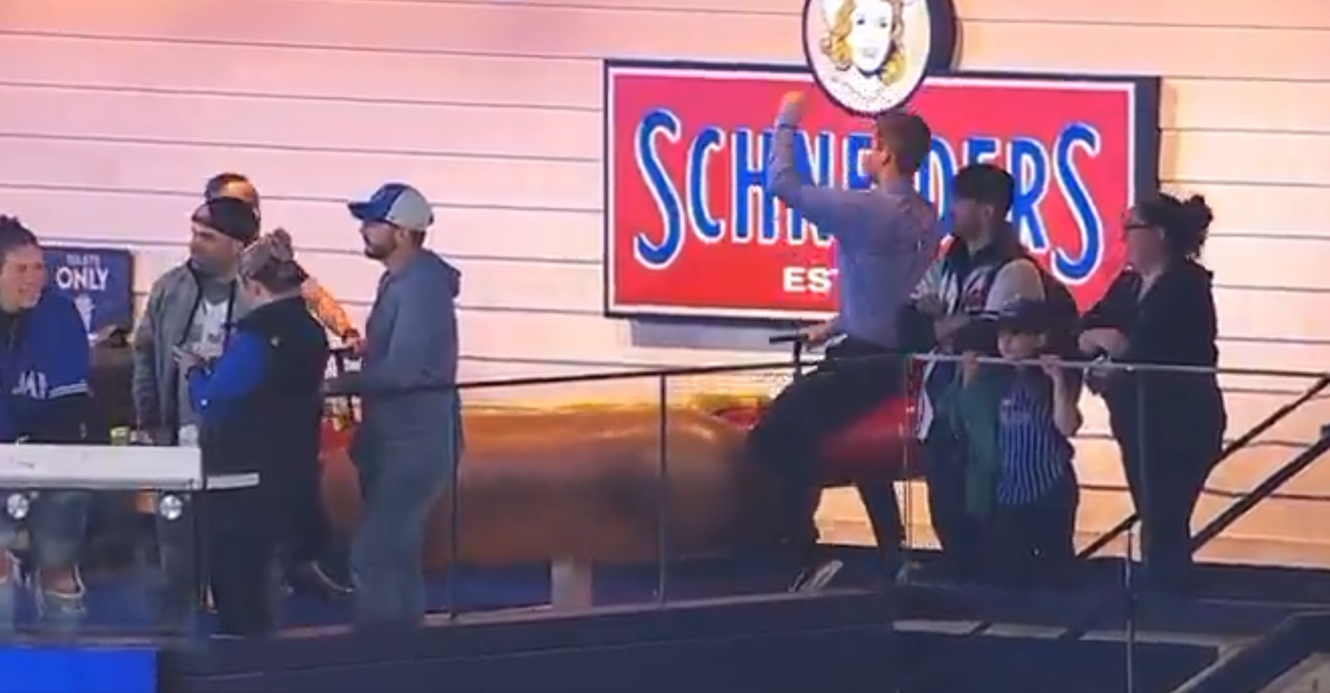 Atlanta Braves reporter Wiley Ballard rides a hotdog seesaw