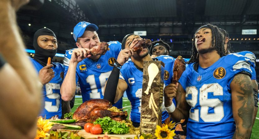 Detroit Lions quarterback Jared Goff (16), defensive tackle DJ Reader (98), wide receiver Amon-Ra St. Brown (14), running back Jahmyr Gibbs (26), linebacker Al-Quadin Muhammad (69) celebrate their win against the Chicago Bears with a turkey drumstick after winning 23-20 on Thanksgiving Day at Ford Field in Detroit on Thursday, Nov. 28, 2024.