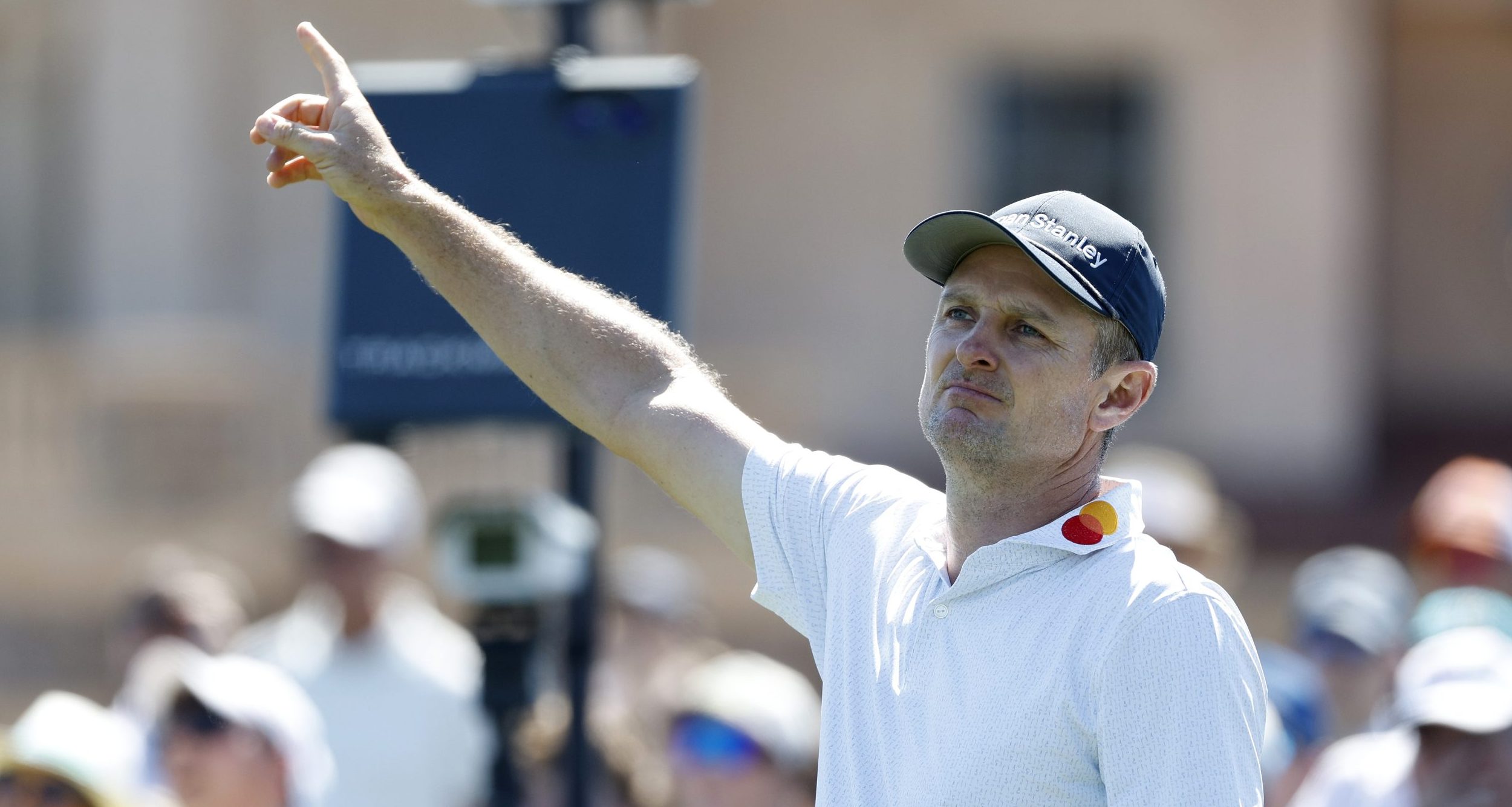 Justin Rose signals wide off of the first tee