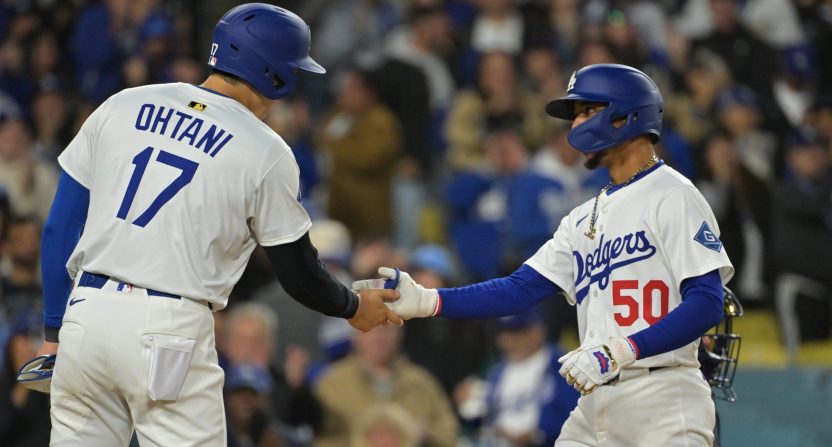 Apr 1, 2025; Los Angeles, California, USA; Los Angeles Dodgers shortstop Mookie Betts (50) shakes hands with designated hitter Shohei Ohtani (17) after hitting a two run home run in the sixth inning against the Atlanta Braves at Dodger Stadium. Mandatory Credit: Jayne Kamin-Oncea-Imagn Images