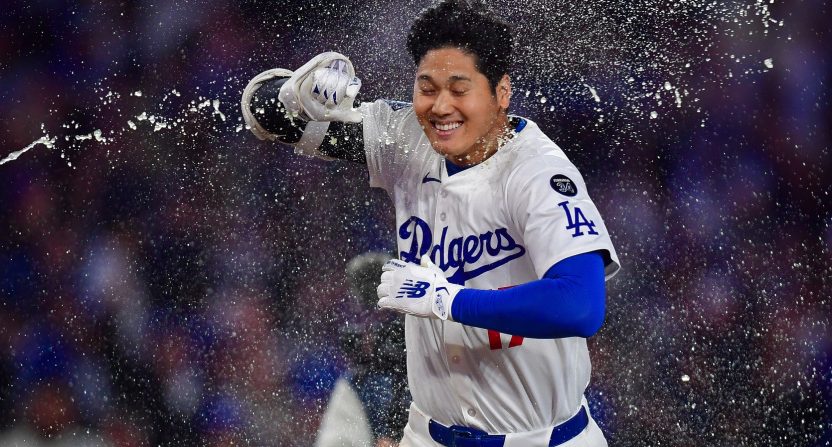 Apr 2, 2025; Los Angeles, California, USA; Los Angeles Dodgers designated hitter Shohei Ohtani (17) is greeted at home after hitting a walk off solo home run against the Atlanta Braves during the ninth inning at Dodger Stadium. Mandatory Credit: Gary A. Vasquez-Imagn Images