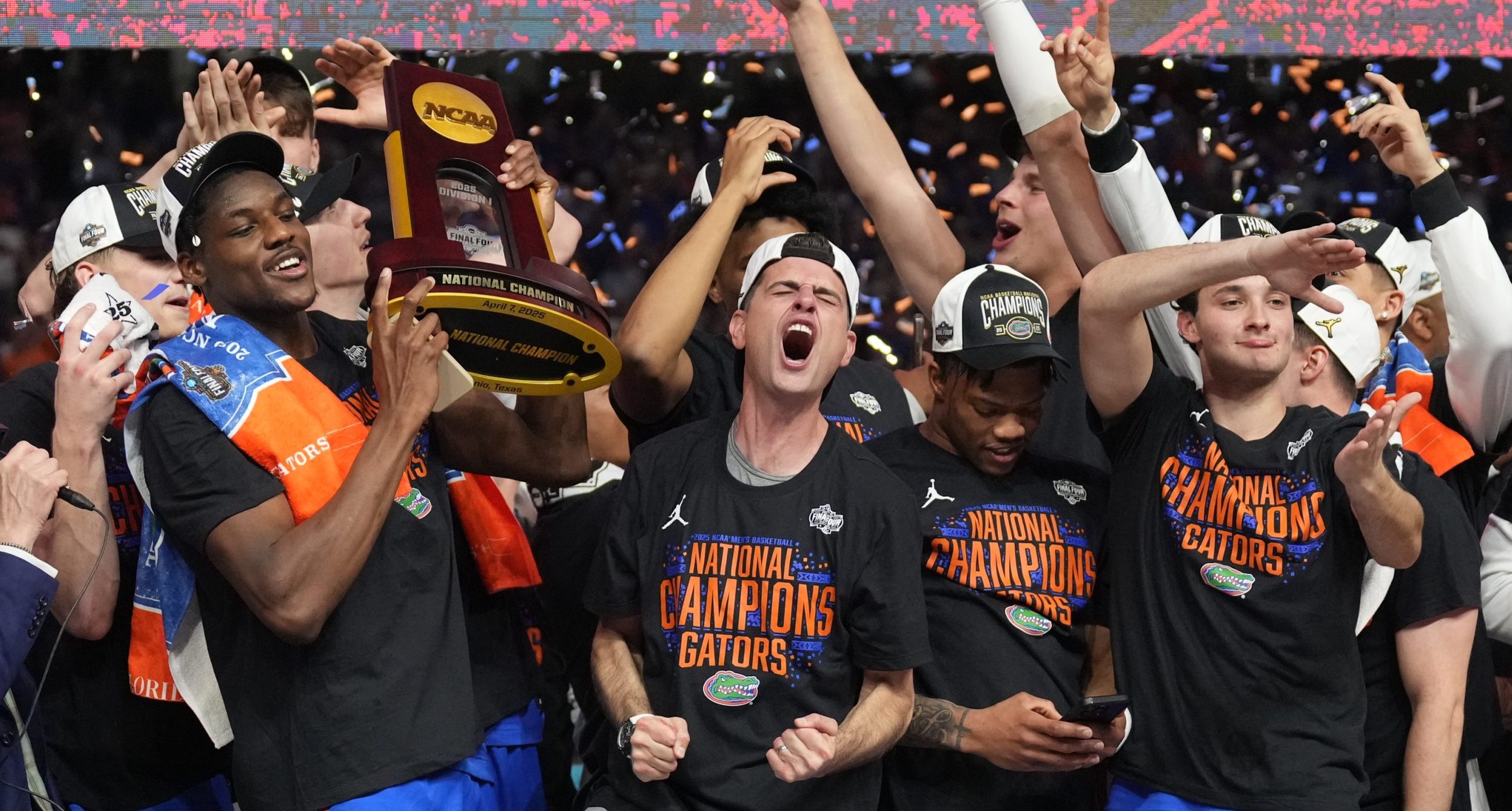 Florida Gators players hoist the trophy