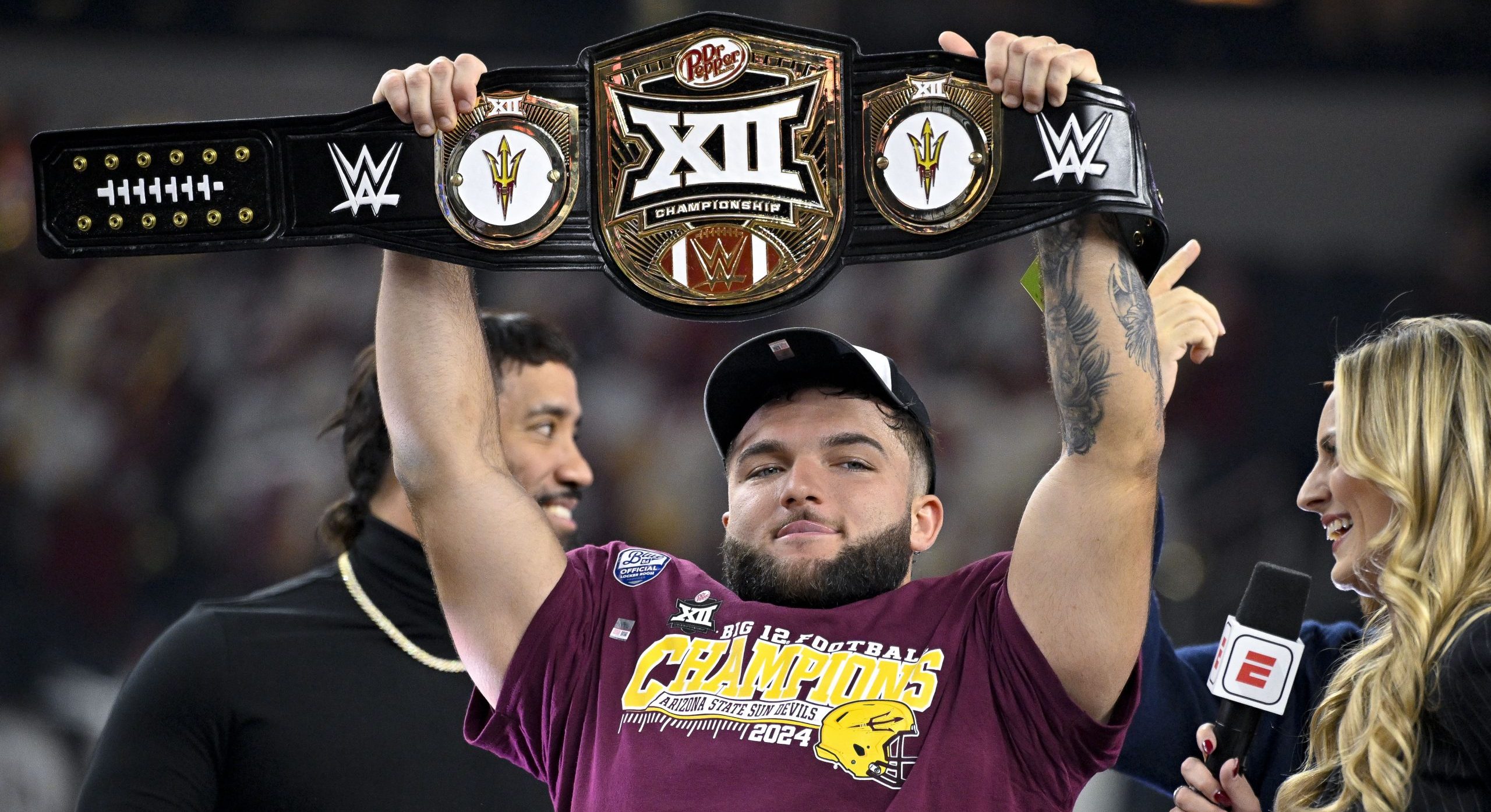 A WWE logo on the Big 12 Championship belt held by former Arizona State running back Cam Skattebo
