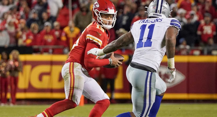 Nov 21, 2021; Kansas City, Missouri, USA; Kansas City Chiefs quarterback Patrick Mahomes (15) looks to pass as Dallas Cowboys outside linebacker Micah Parsons (11) defends during the game at GEHA Field at Arrowhead Stadium. Mandatory Credit: Denny Medley-USA TODAY Sports
