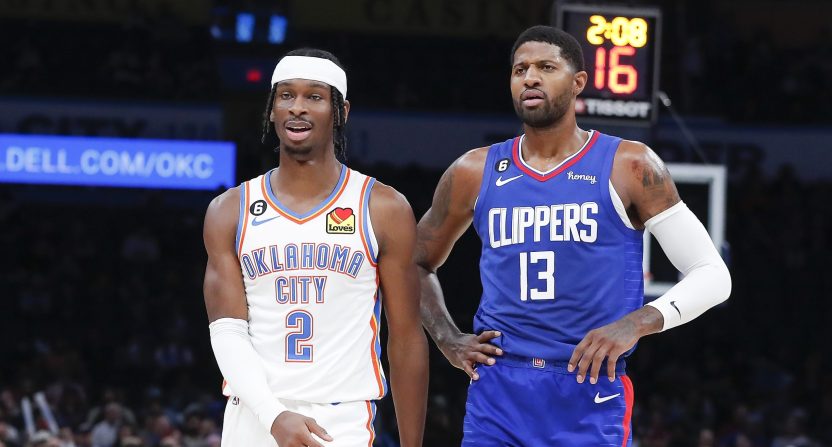 Oct 27, 2022; Oklahoma City, Oklahoma, USA; Oklahoma City Thunder guard Shai Gilgeous-Alexander (2) and LA Clippers guard Paul George (13) walks down the court during a time out during the first half at Paycom Center.