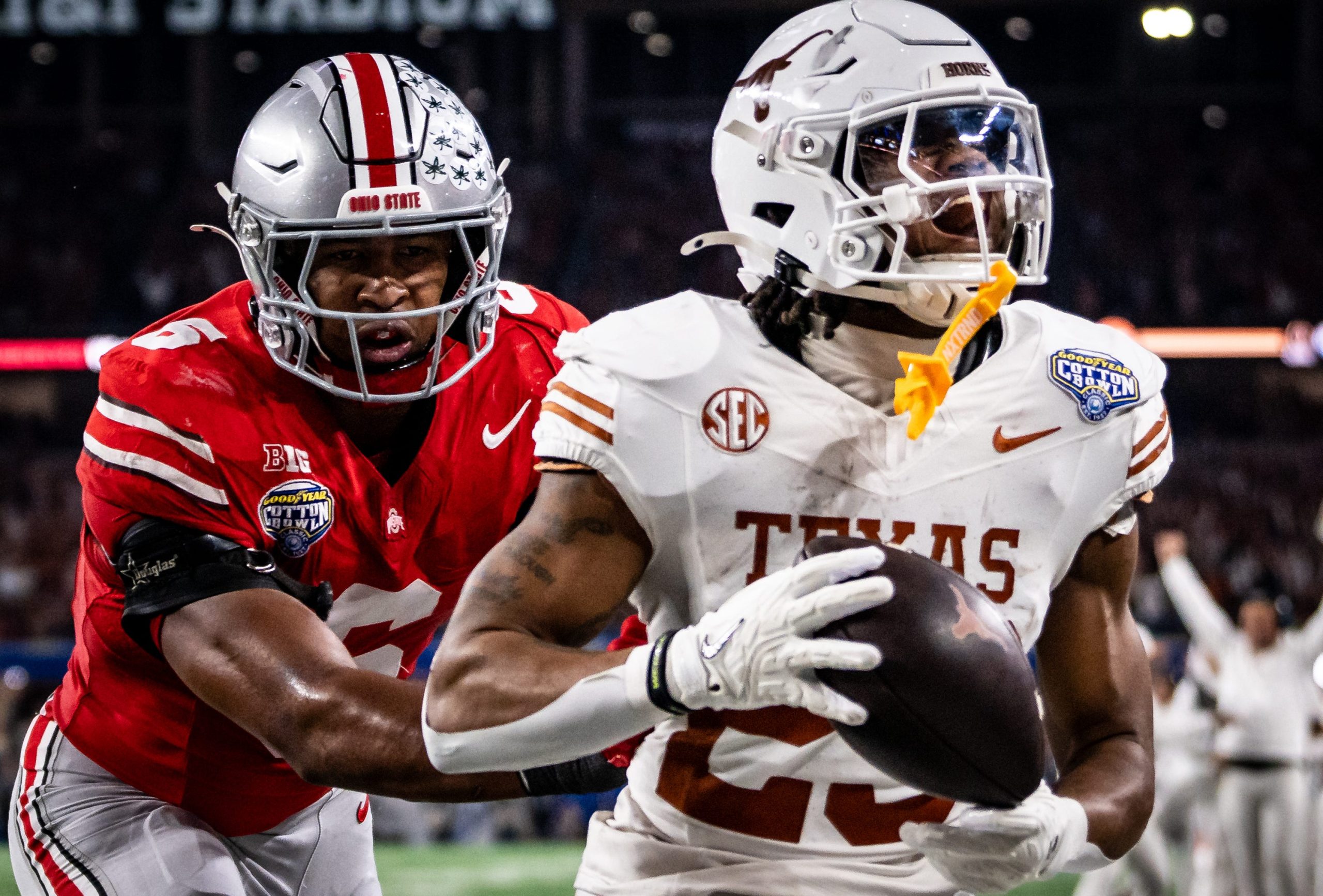 Texas Longhorns running back Jaydon Blue (23) runs into the end zone to score after catching a pass from quarterback Quinn Ewers (3) while Ohio State Buckeyes safety Sonny Styles (6) runs to defend late in the second quarter as the Texas Longhorns play the Ohio State Buckeyes in the Cotton Bowl College Football Playoff semi-final at AT&T Stadium in Dallas, Texas, Jan. 10, 2025.