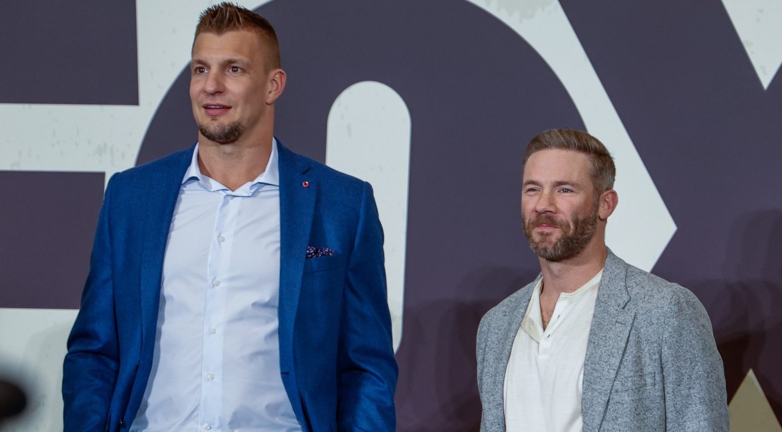 Former New England Patriots Rob Gronkowski and Julian Edelman defended Bill Belichick's girlfriend, Jordon Hudson.