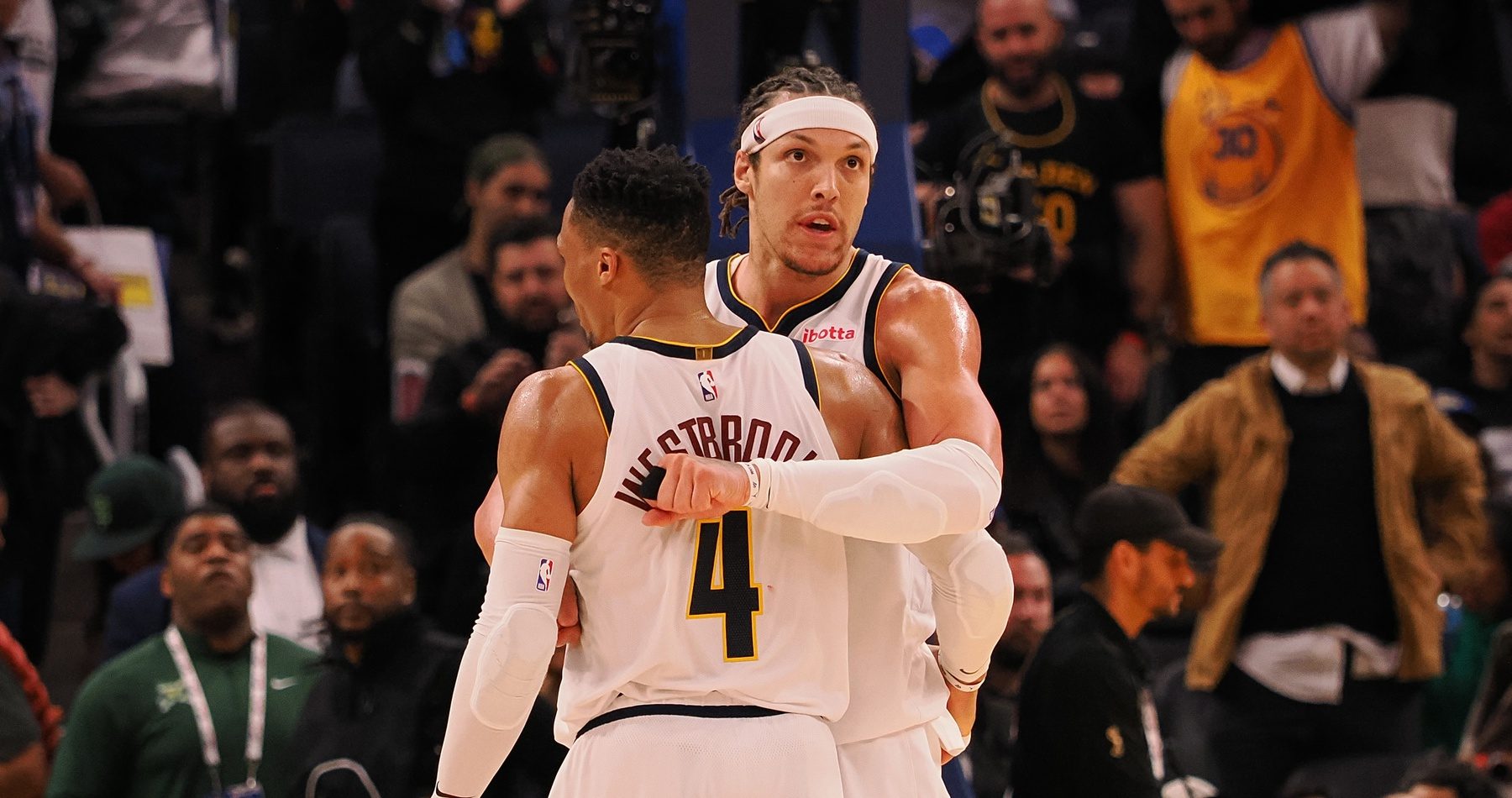 Denver Nuggets guard Russell Westbrook (4) and forward Aaron Gordon (32) hug during the final seconds of the fourth quarter against the Golden State Warriors at Chase Center.