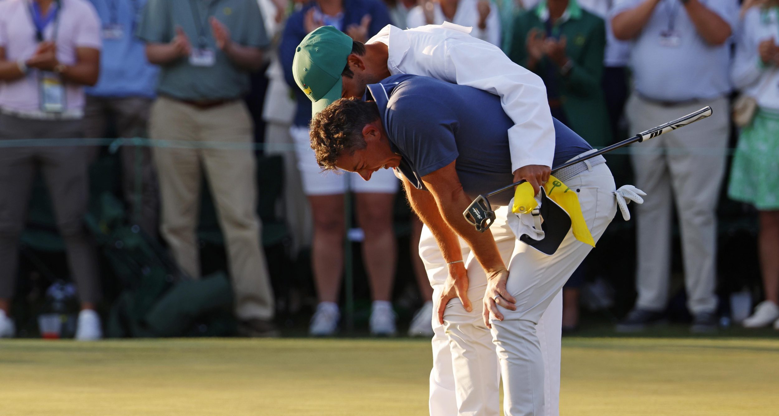 Apr 13, 2025; Augusta, Georgia, USA; Rory McIlroy celebrates with his caddy, Harry Diamond, after winning in a playoff on the 18th green during the final round of the Masters Tournament at Augusta National Golf Club.