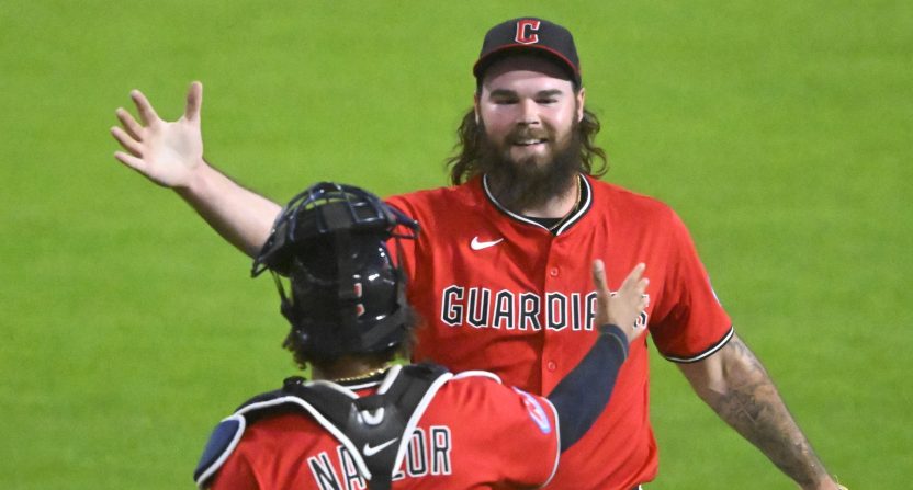 Cleveland Guardians relief pitcher Hunter Gaddis (33) and catcher Bo Naylor (23) celebrate a win over the Milwaukee Brewers at Progressive Field.