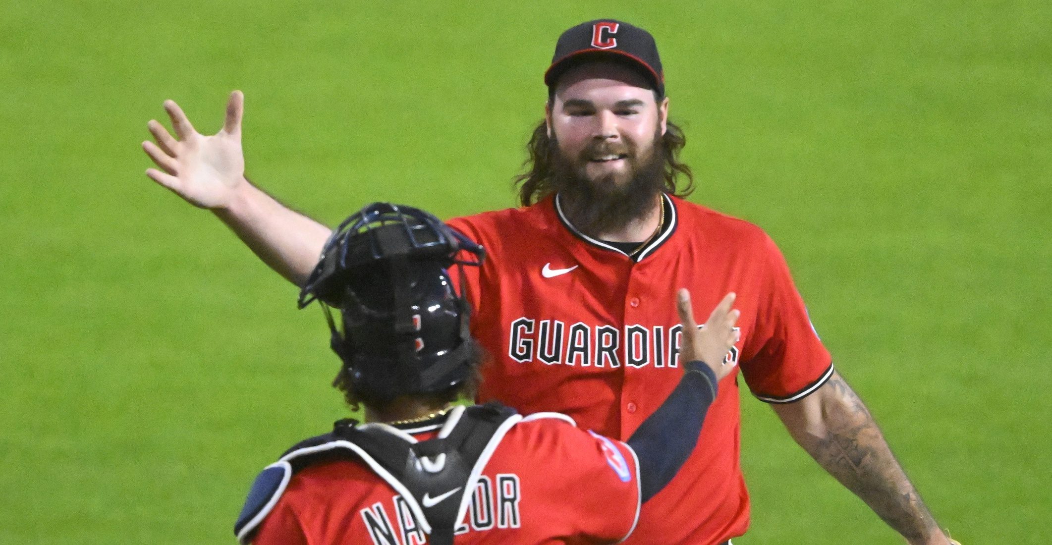 Cleveland Guardians relief pitcher Hunter Gaddis (33) and catcher Bo Naylor (23) celebrate a win over the Milwaukee Brewers at Progressive Field.