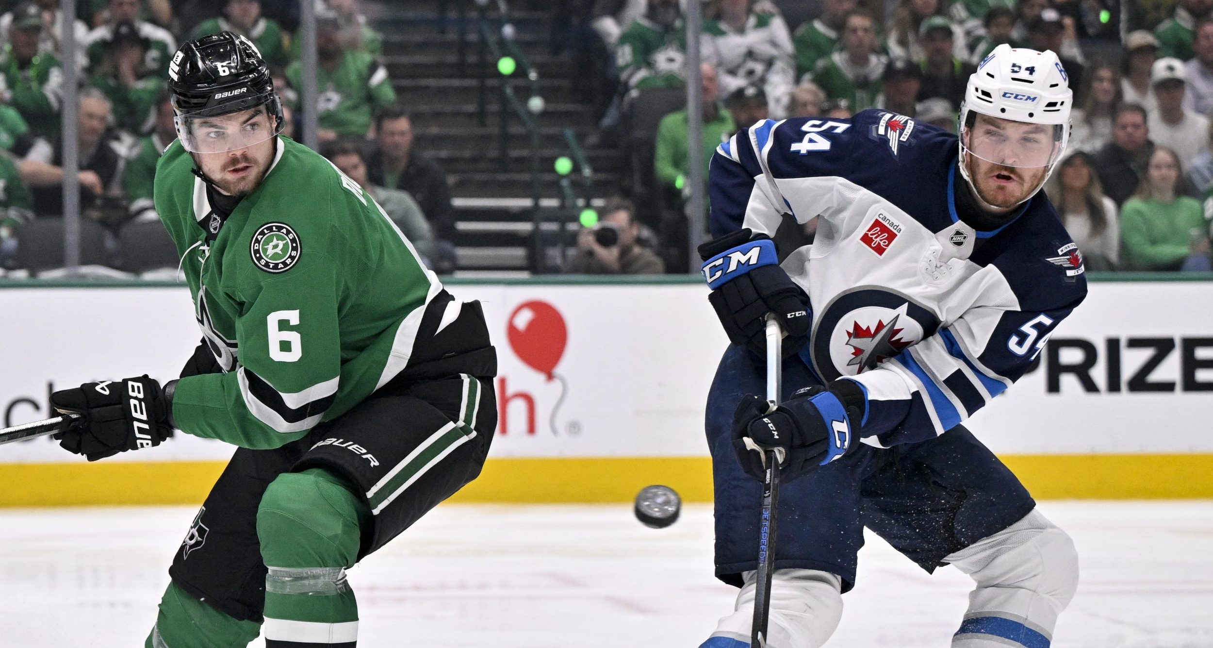 Dallas Stars defenseman Lian Bichsel (6) and Winnipeg Jets defenseman Dylan Samberg