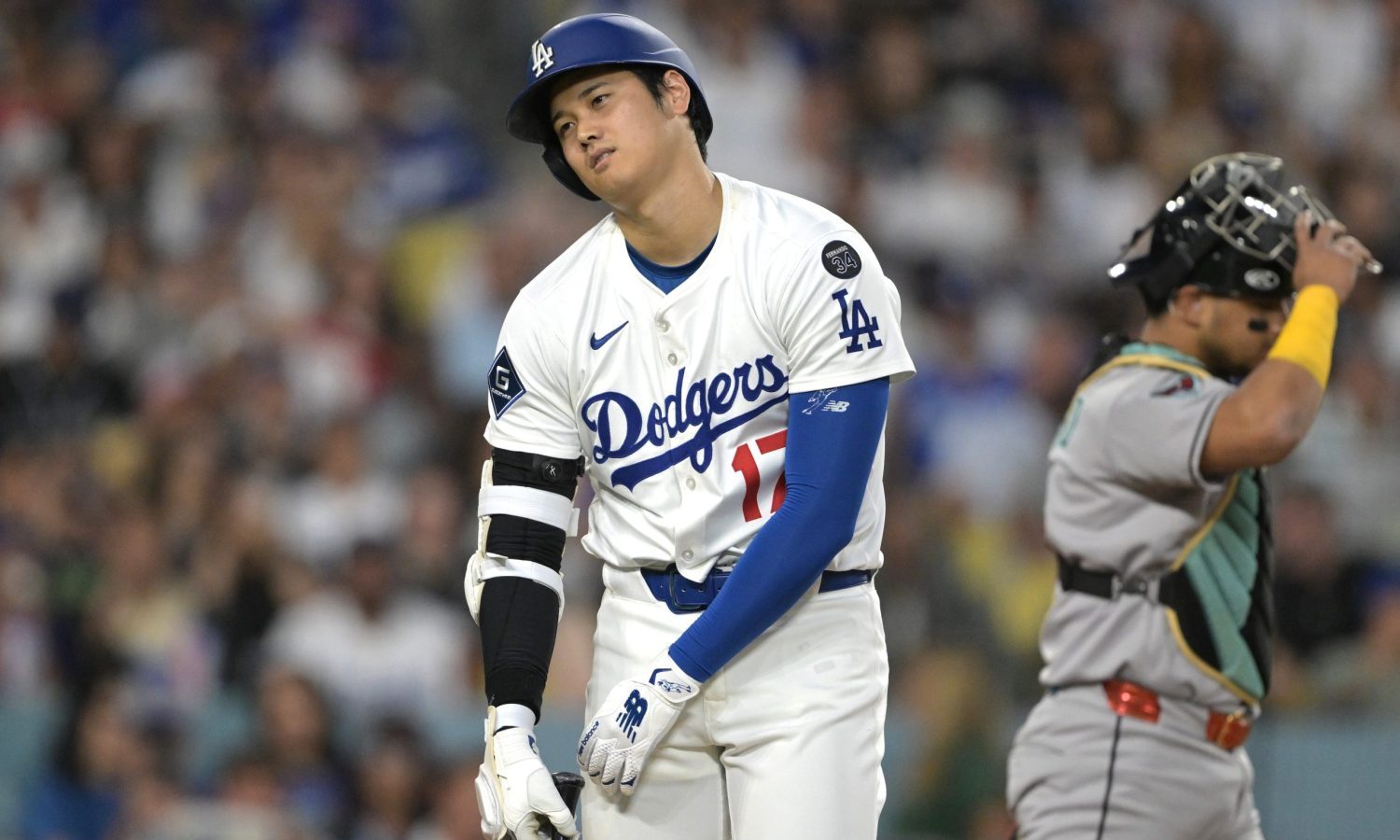 May 21, 2025; Los Angeles, California, USA; Los Angeles Dodgers designated hitter Shohei Ohtani (17) reacts after fouling a ball off his leg in the sixth inning against the Arizona Diamondbacks at Dodger Stadium.