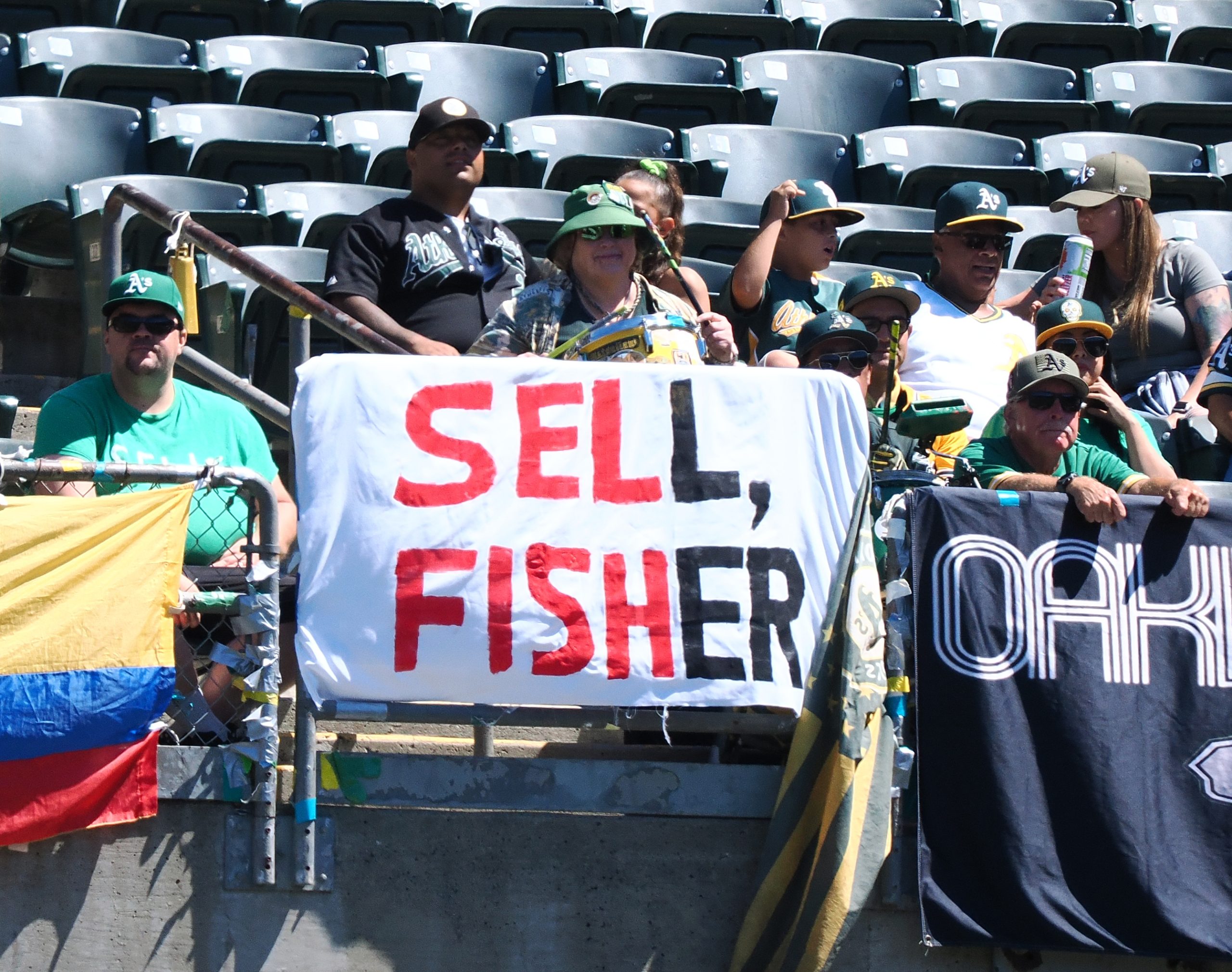 Sep 4, 2023; Oakland, California, USA; A sign reading sell, Fisher displayed along the outfield wall in reference Oakland Athletics owner John Fisher (not pictured) during the first inning against the Toronto Blue Jays at Oakland-Alameda County Coliseum. Mandatory Credit: Kelley L Cox-USA TODAY Sports