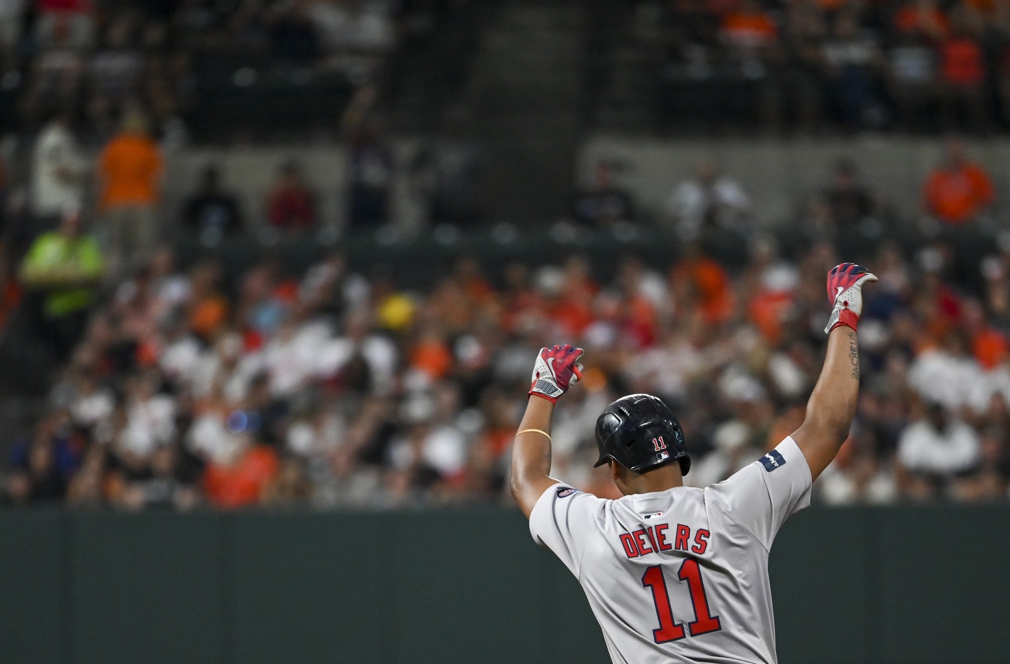 Boston Red Sox third baseman Rafael Devers (11) reacts after hitting a third inning two run home run against the Baltimore Orioles at Oriole Park at Camden Yards.