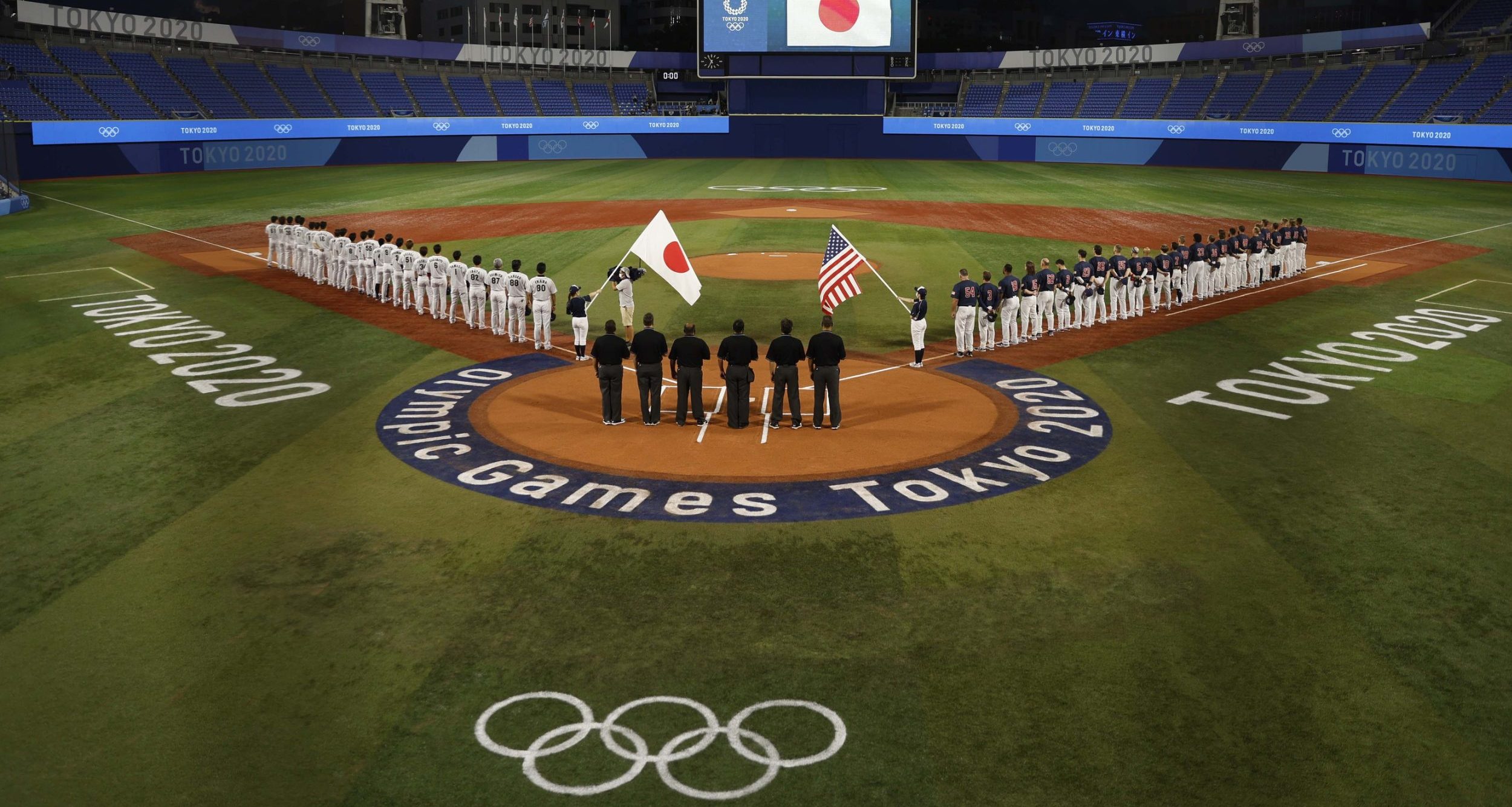 Japan and USA line up for the national anthems before playing in the baseball gold medal match during the Tokyo 2020 Olympic Summer Games