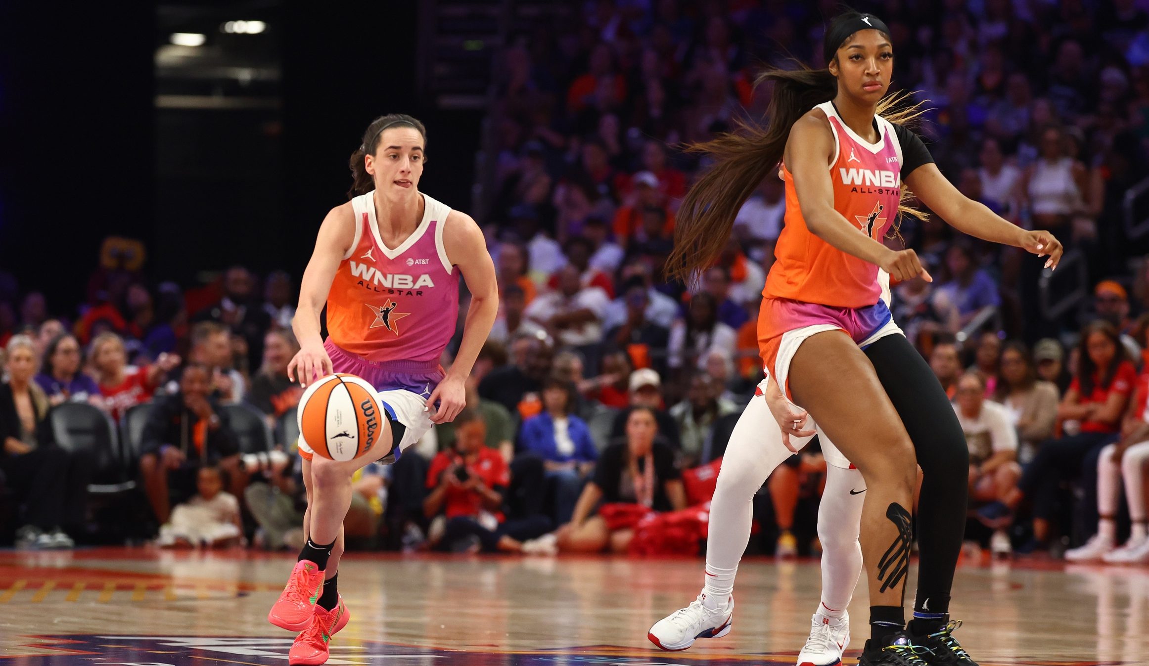 Jul 20, 2024; Phoenix, AZ, USA; Team WNBA guard Caitlin Clark (left) and Angel Reese against the USA Women's National Team during the 2024 WNBA All Star Game at Footprint Center. Mandatory Credit: Mark J. Rebilas-USA TODAY Sports