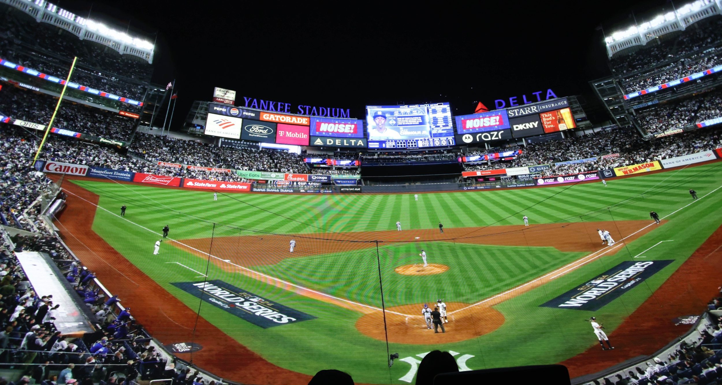 Fans watch a giant LED screen showing Game 4 of the World Series between the Los Angeles Dodgers and the New York Yankees live at Cosm Los Angeles.