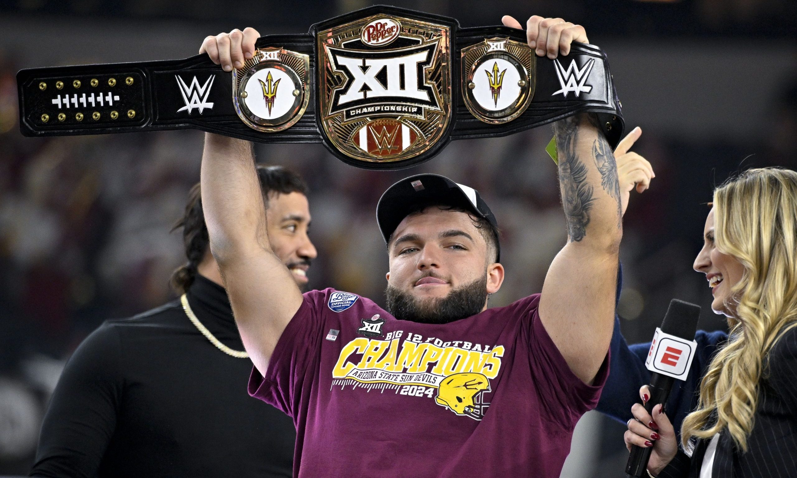 Dec 7, 2024; Arlington, TX, USA; Arizona State Sun Devils running back Cam Skattebo (4) holds up the WWE Big 12 championship belt after the Sun Devils defeat the Iowa State Cyclones and win the 2024 Big 12 Championship at AT&T Stadium. Mandatory Credit: Jerome Miron-Imagn Images