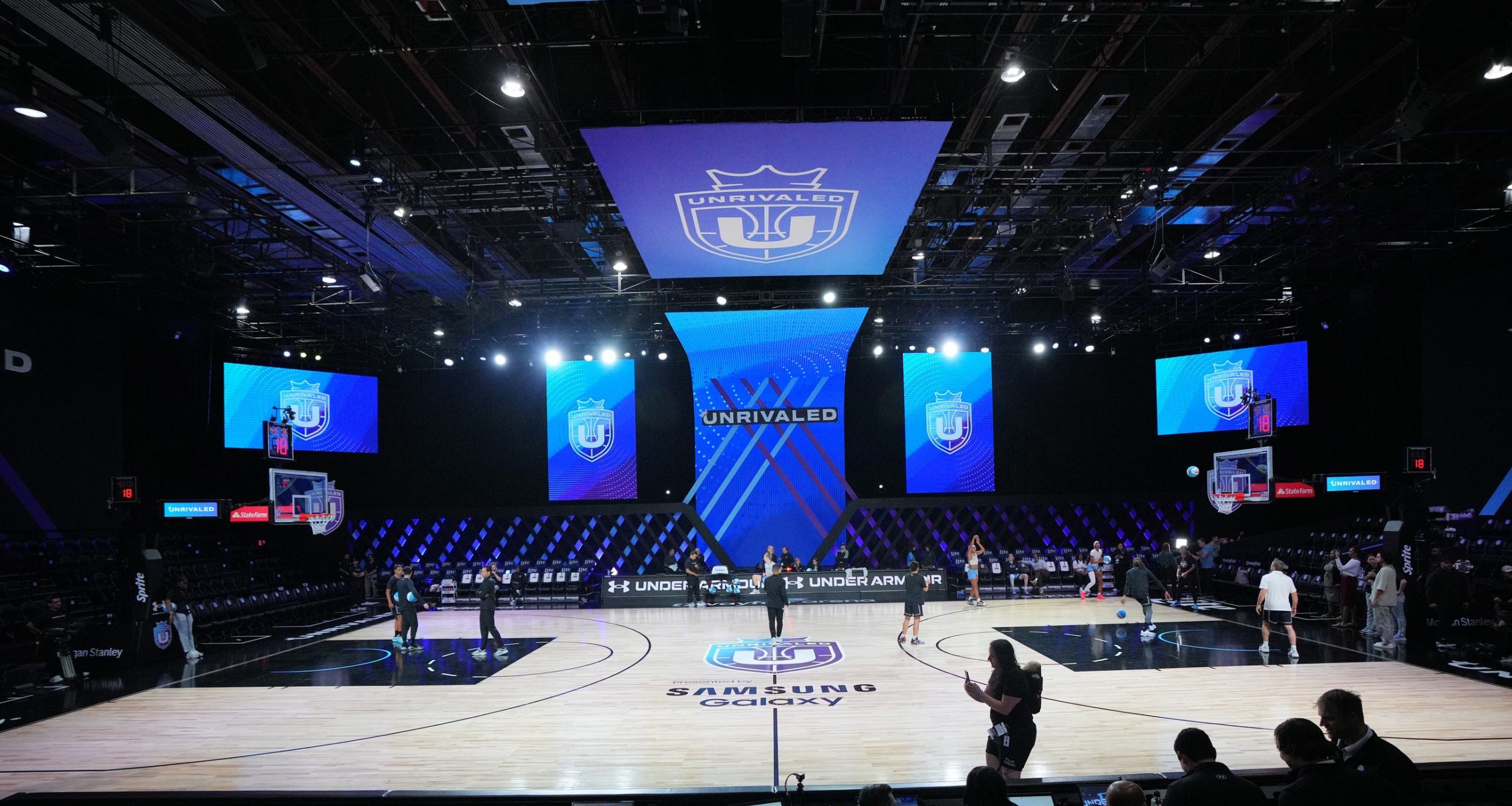 Players warm-up before the game between the Mist and the Lunar Owls of the Unrivaled women’s professional 3v3 basketball league at Wayfair Arena.