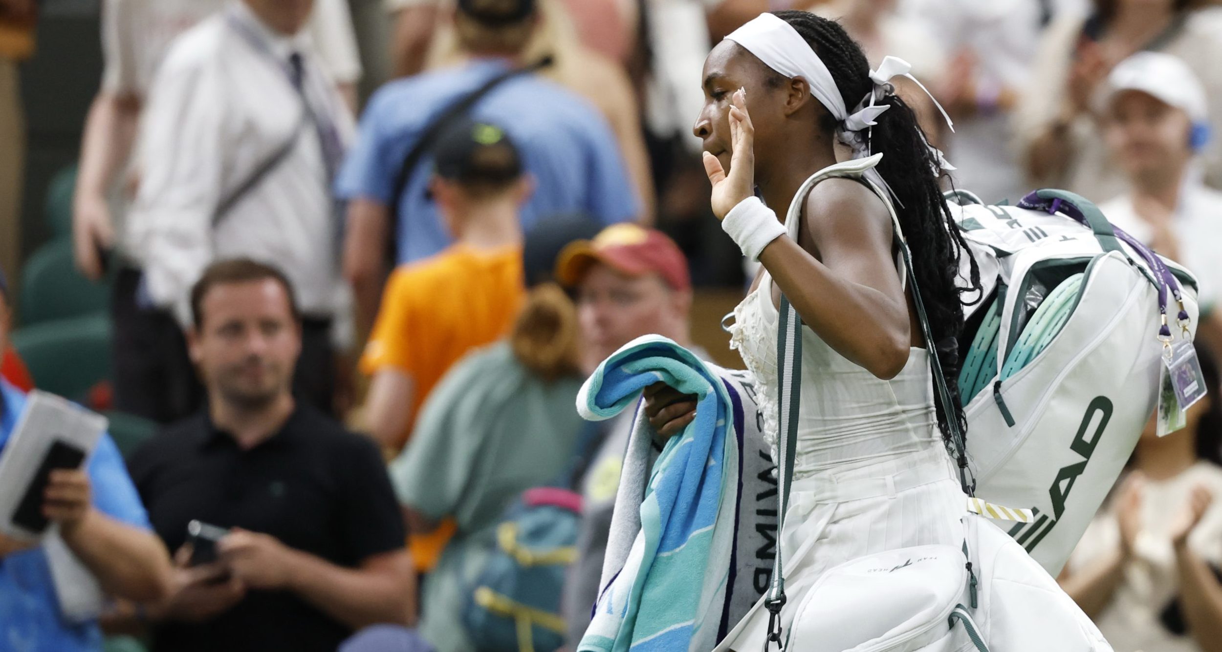 Coco Gauff (USA) waves to the crowd while leaving the court after her match